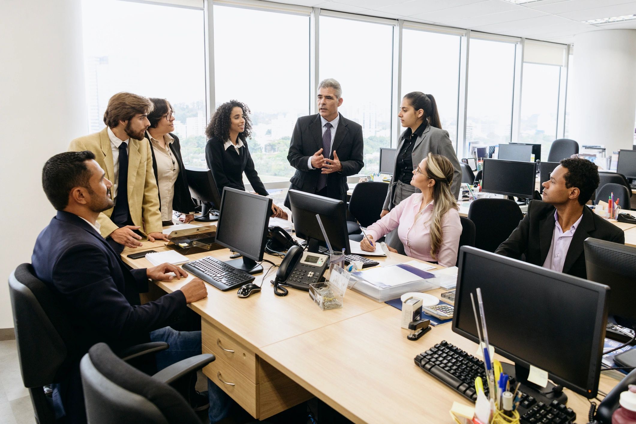 Mature business manager explaining to colleagues in meeting